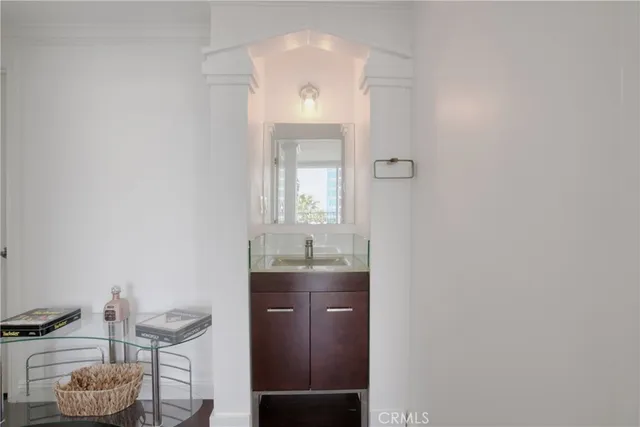 a bathroom with a granite countertop sink a toilet and mirror