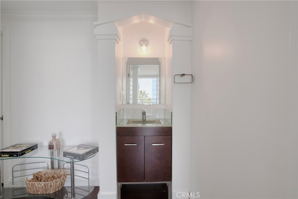 700 East Ocean Boulevard, Unit 1104 Long Beach, CA 90802 - Photo 26 of 47 a bathroom with a granite countertop sink a toilet and mirror