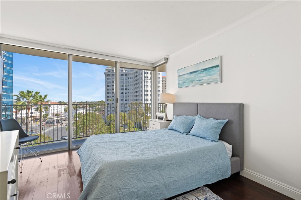 700 East Ocean Boulevard, Unit 1104 Long Beach, CA 90802 - Photo 27 of 47 a bedroom with a large window and a balcony