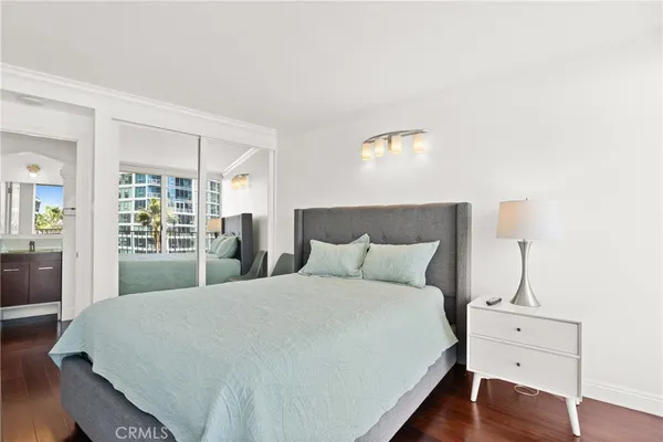 a large bed sitting in a bedroom next to a window with lamp