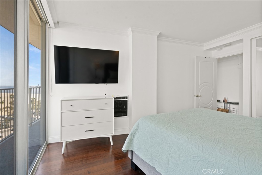700 East Ocean Boulevard, Unit 1104 Long Beach, CA 90802 - Photo 31 of 47 a bedroom with a bed and a flat screen tv