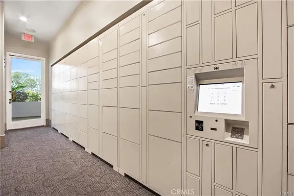 a view of a refrigerator in kitchen and white cabinets