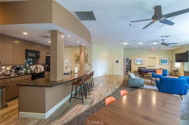 a view of a living room kitchen and a wooden floor