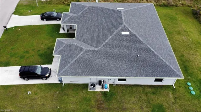 an aerial view of a house with pool a yard and outdoor seating
