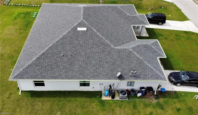 an aerial view of a house with a yard