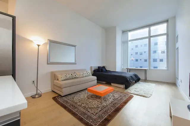 a bedroom with a bed and couch