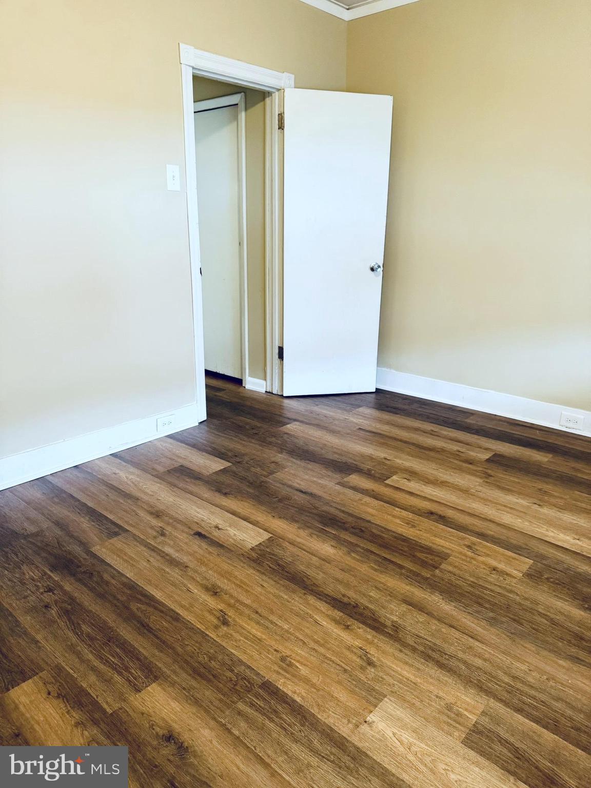 2246 South Bucknell Street Philadelphia, PA 19145 - Photo 10 of 25 a view of an empty room with wooden floor and a window