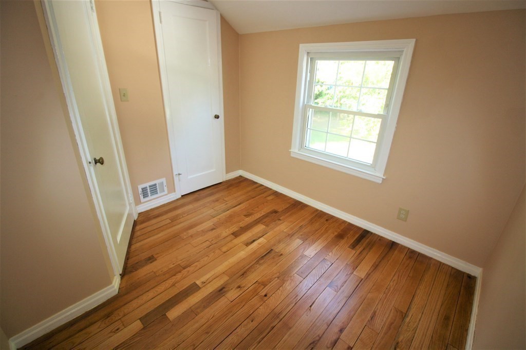 116 Donbray Road Springfield, MA 01119 - Photo 12 of 42 a view of an empty room with wooden floor and a window