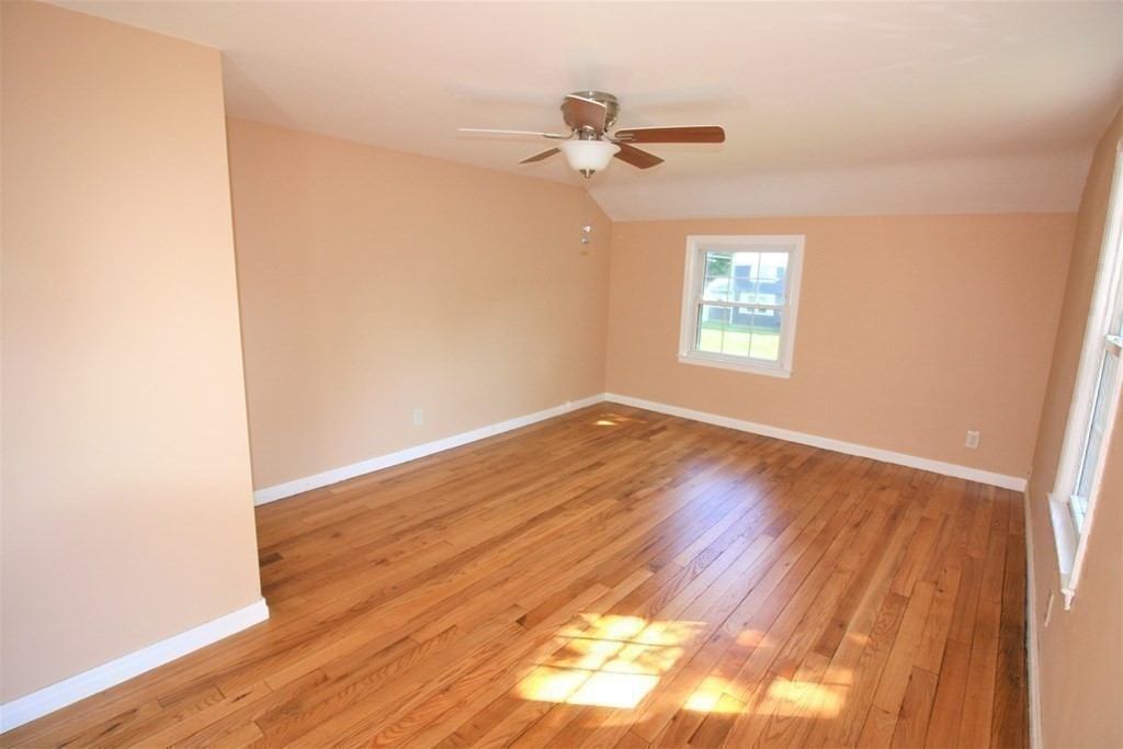 116 Donbray Road Springfield, MA 01119 - Photo 16 of 42 an empty room with wooden floor fan and windows