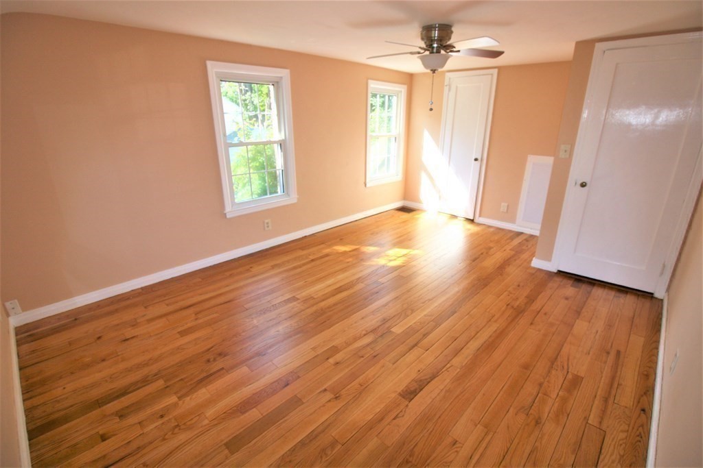 116 Donbray Road Springfield, MA 01119 - Photo 17 of 42 an empty room with wooden floor and windows