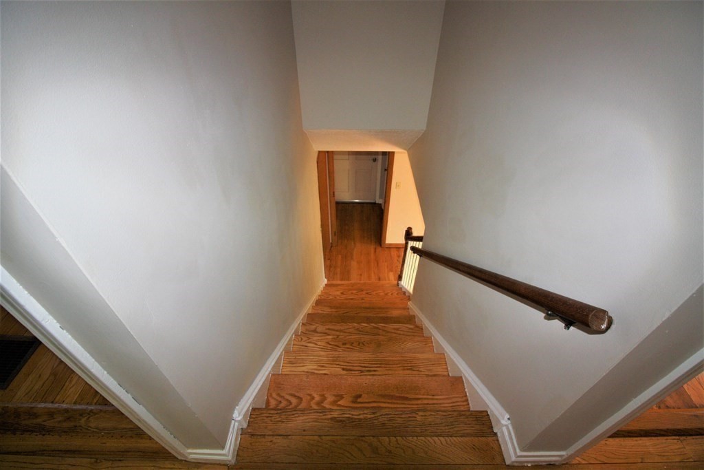 116 Donbray Road Springfield, MA 01119 - Photo 20 of 42 a view of a hallway with wooden floor and staircase