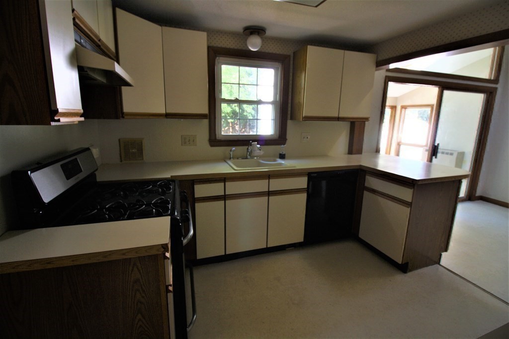 116 Donbray Road Springfield, MA 01119 - Photo 23 of 42 a kitchen with a sink a stove and cabinets