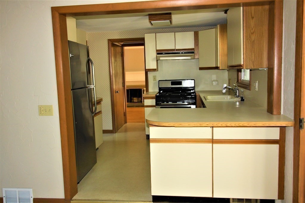 116 Donbray Road Springfield, MA 01119 - Photo 26 of 42 a kitchen with a refrigerator a stove and a microwave