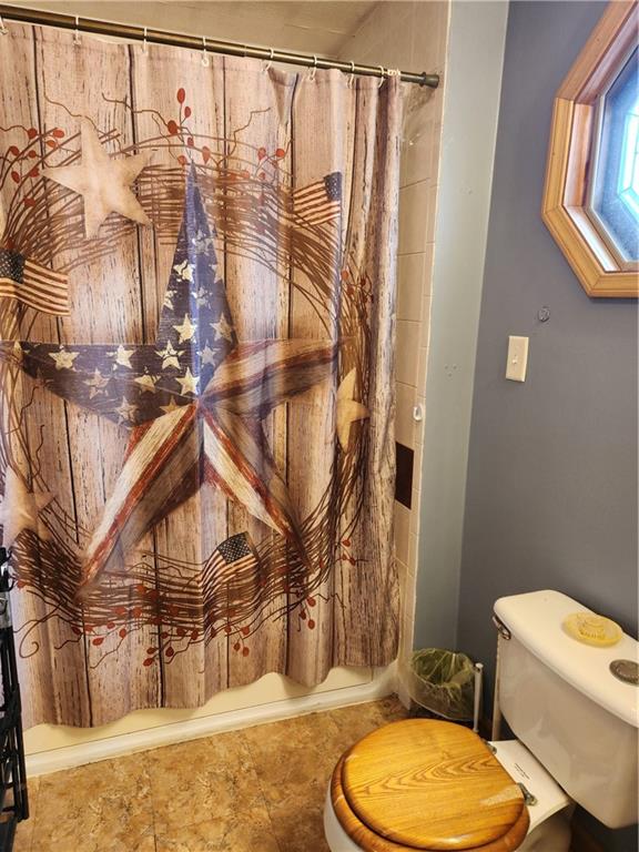 221 Meadowview Drive Latrobe, PA 15650 - Photo 12 of 15 a bathroom with a toilet a sink and a shower curtain