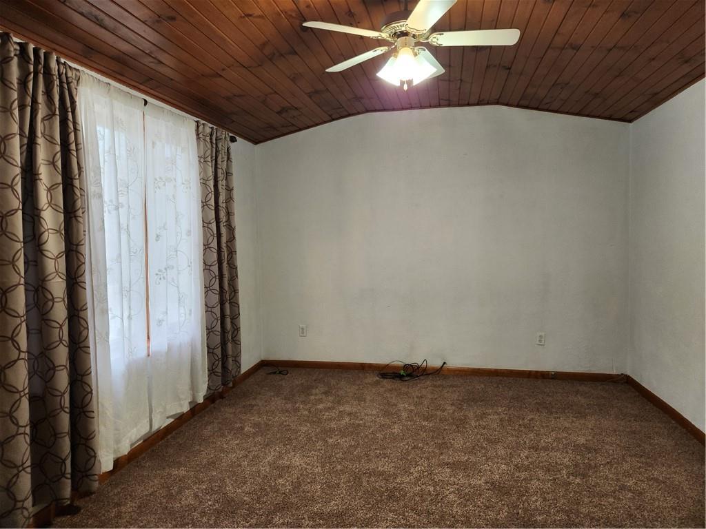 221 Meadowview Drive Latrobe, PA 15650 - Photo 8 of 15 an empty room with a chandelier fan and windows