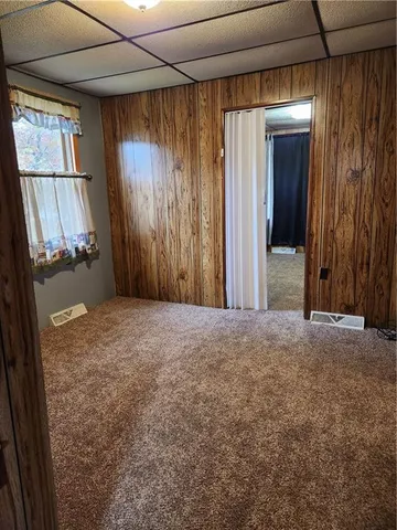 a view of a room with a fireplace and a window