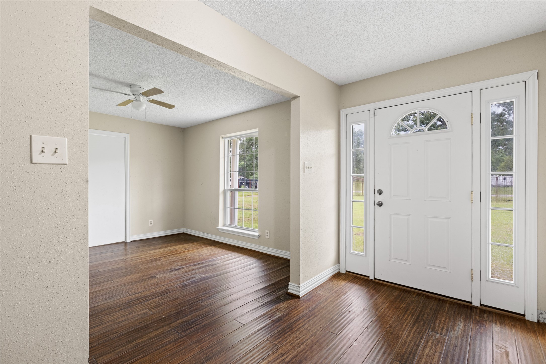 27093 Frye Road Splendora, TX 77372 - Photo 11 of 32 an empty room with wooden floor and windows