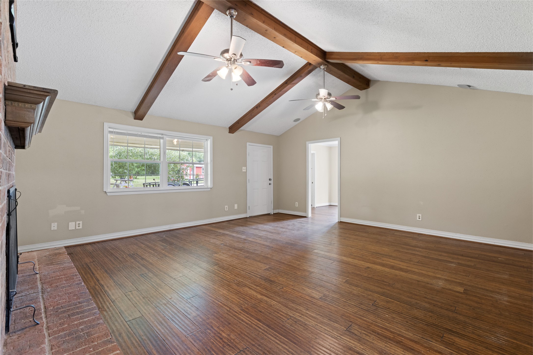 27093 Frye Road Splendora, TX 77372 - Photo 13 of 32 a view of an empty room with wooden floor and a window