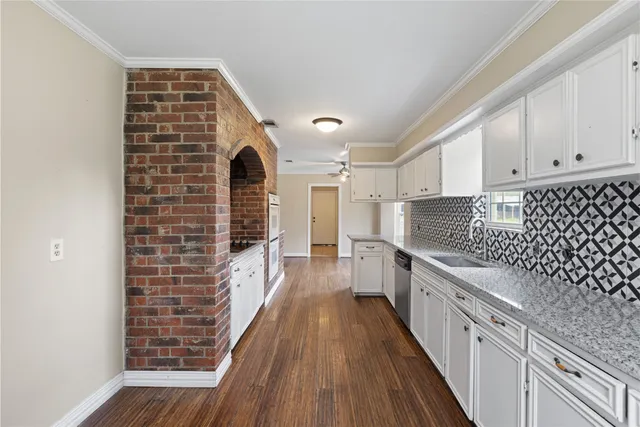 a kitchen with granite countertop white cabinets and white appliances