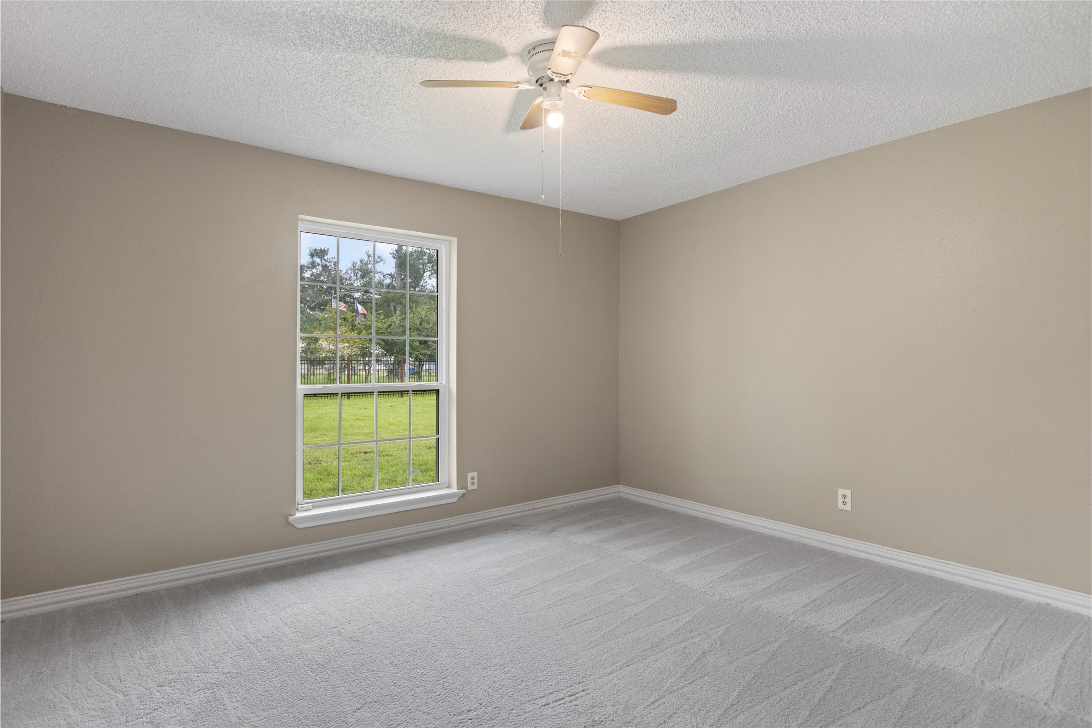 27093 Frye Road Splendora, TX 77372 - Photo 23 of 32 an empty room with a window and a fan
