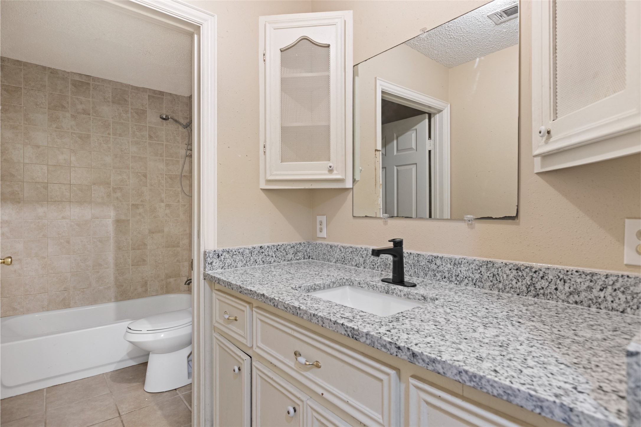 27093 Frye Road Splendora, TX 77372 - Photo 25 of 32 a bathroom with a granite countertop sink a toilet and bathtub