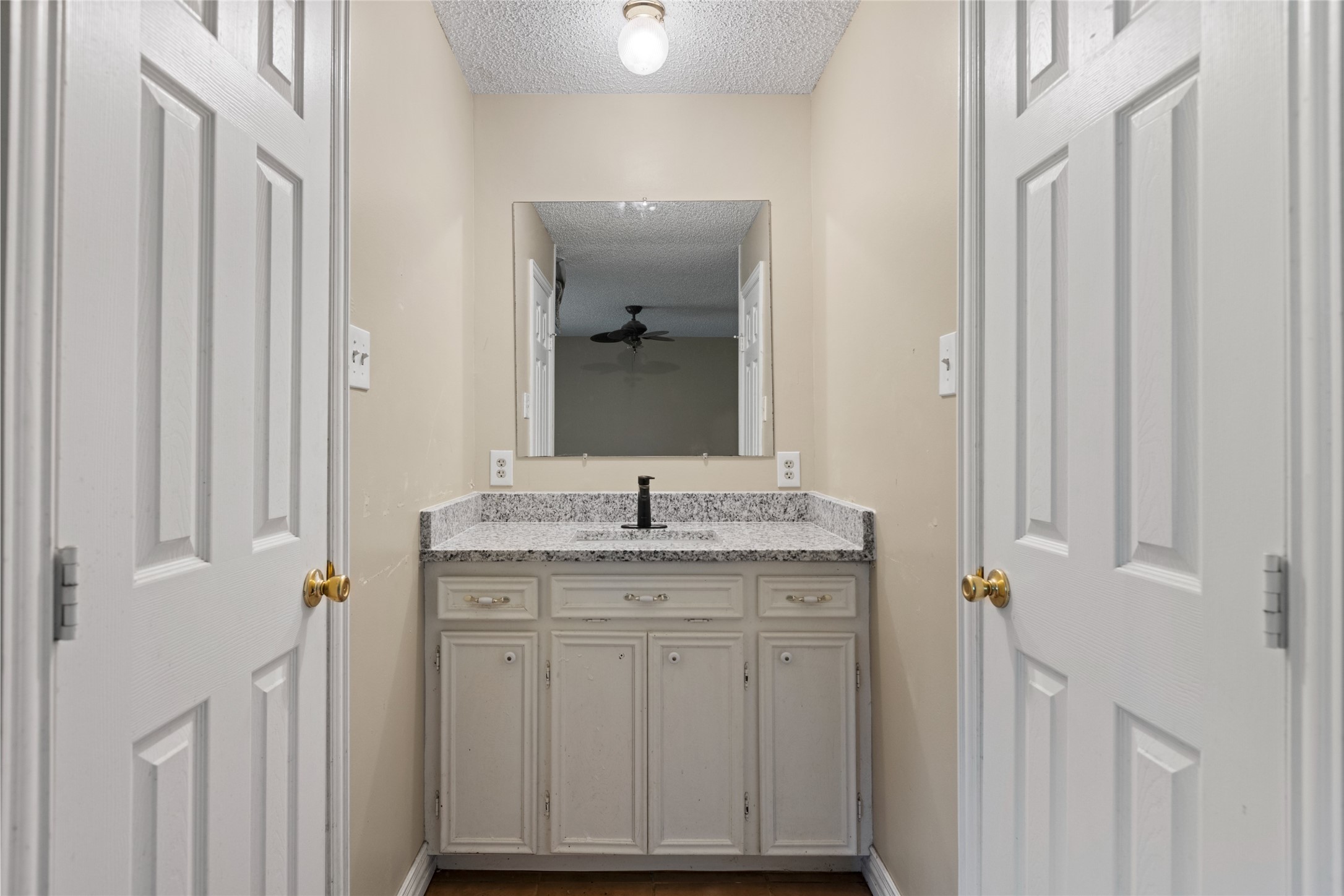 27093 Frye Road Splendora, TX 77372 - Photo 29 of 32 a bathroom with a granite countertop sink a toilet and a mirror