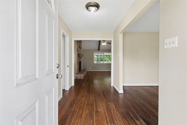 a view of a hallway with wooden floor