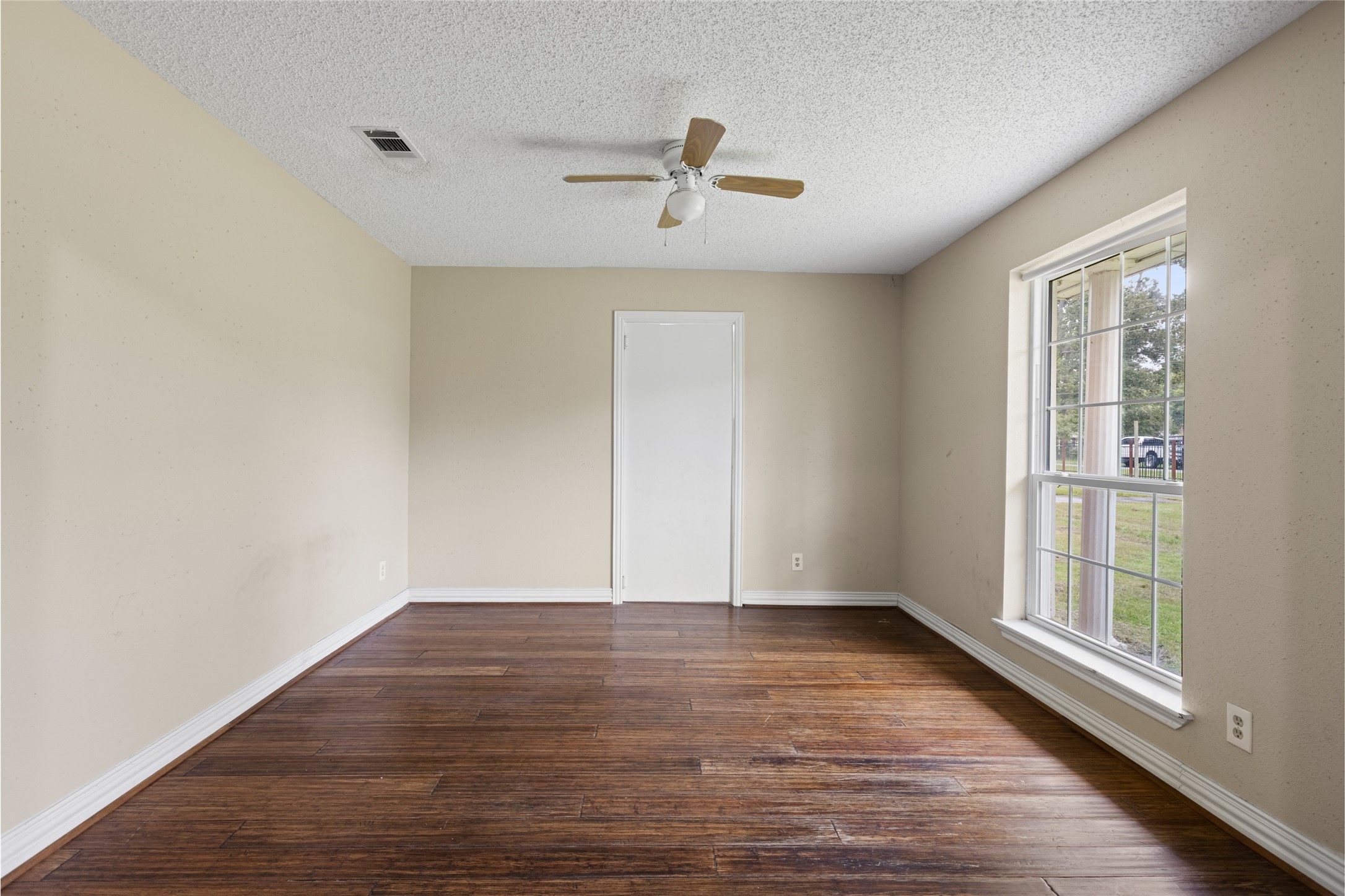 27093 Frye Road Splendora, TX 77372 - Photo 10 of 32 wooden floor in an empty room with a window