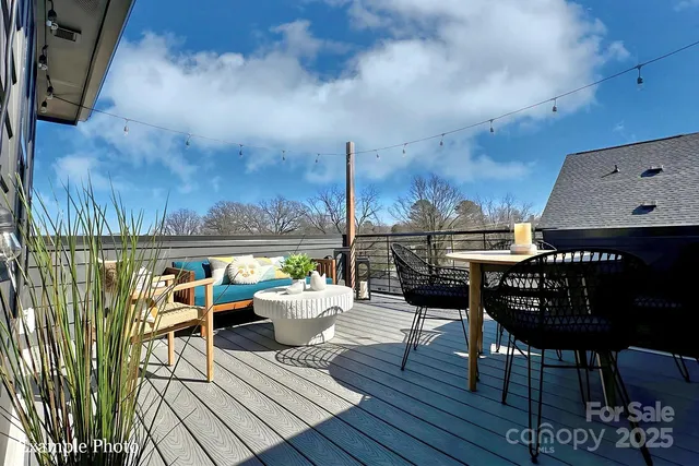 a view of a roof deck with table and chairs