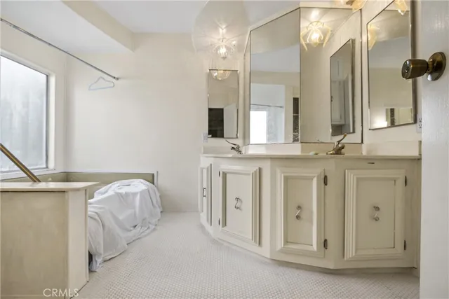 a bathroom with a double vanity sink and a mirror