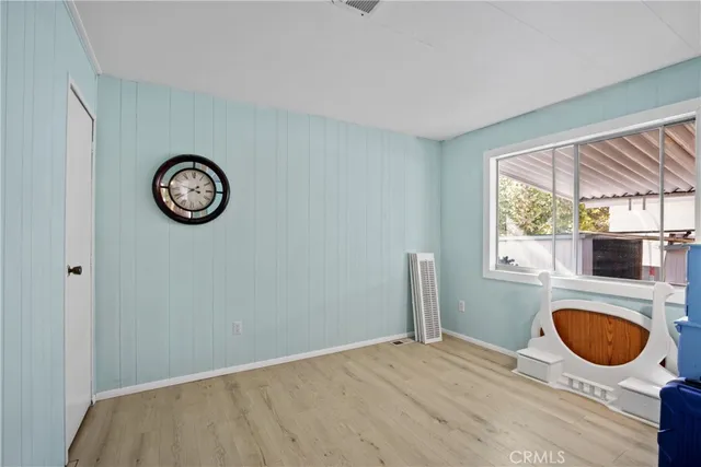 a view of a livingroom with wooden floor and a window