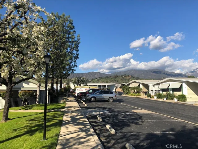 a view of city street with a car parked on the road