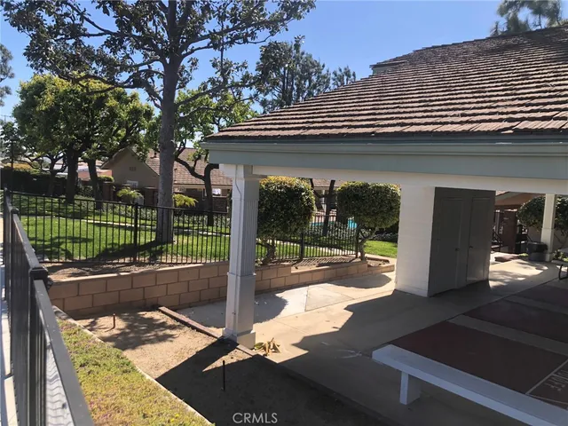 a view of a patio with a table chairs and a backyard