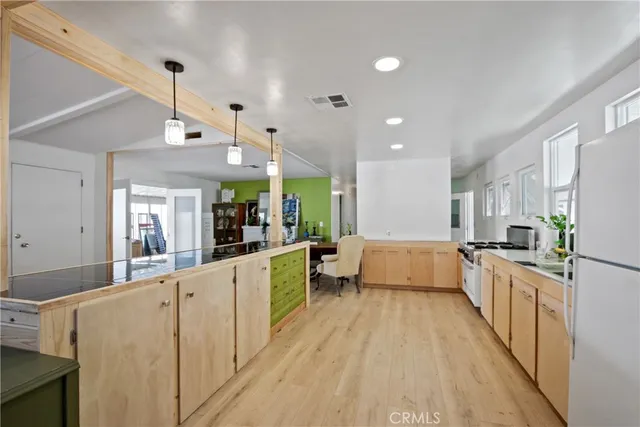 a large white kitchen with stainless steel appliances