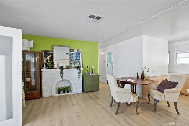 a dining room with furniture and a kitchen view