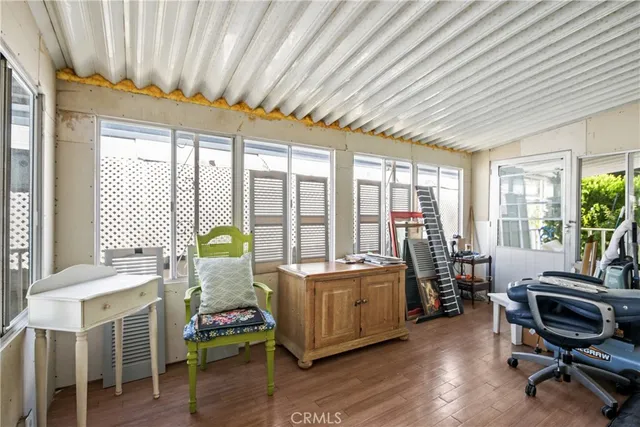 a living room with furniture and large windows
