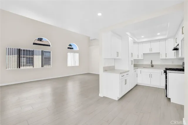 a kitchen with white cabinets and white appliances