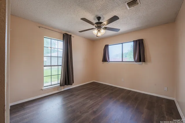 a bathroom with a granite countertop sink toilet and a mirror