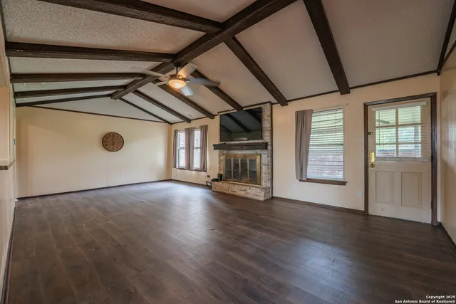 a view of a kitchen with a sink and a refrigerator