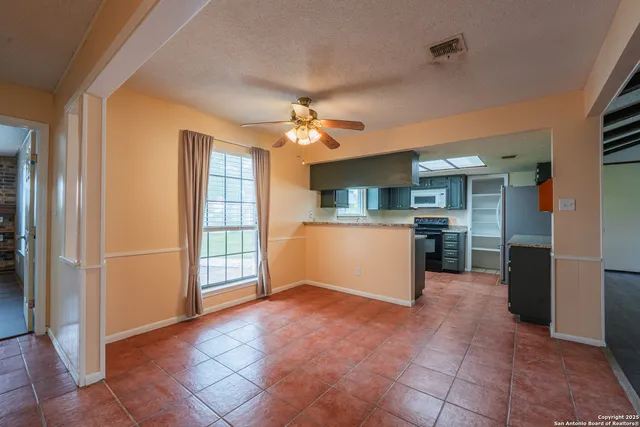 a kitchen with granite countertop a stove and a microwave