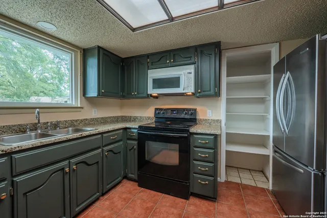 a kitchen with a stove and a refrigerator