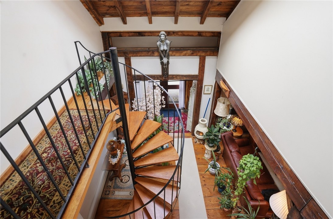 186 Arcadia Road Hopkinton, RI 02832 - Photo 15 of 27 Stairwell offering natural light and a warm, inviting atmosphere, providing easy access to the bedrooms located on the upper level of the home.