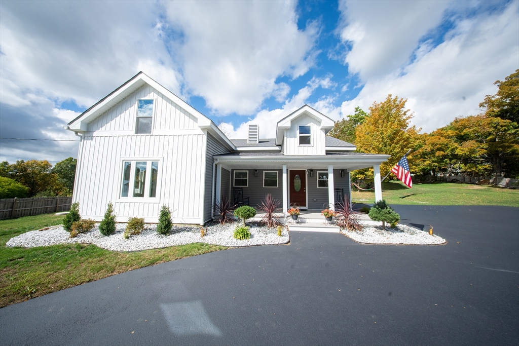 293 Brookfield Road Brimfield, MA 01010 - Photo 1 of 30 a front view of a house with a garden and patio