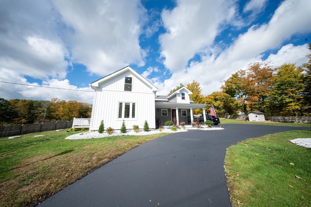 293 Brookfield Road Brimfield, MA 01010 - Photo 2 of 30 a front view of a house with a yard and trees