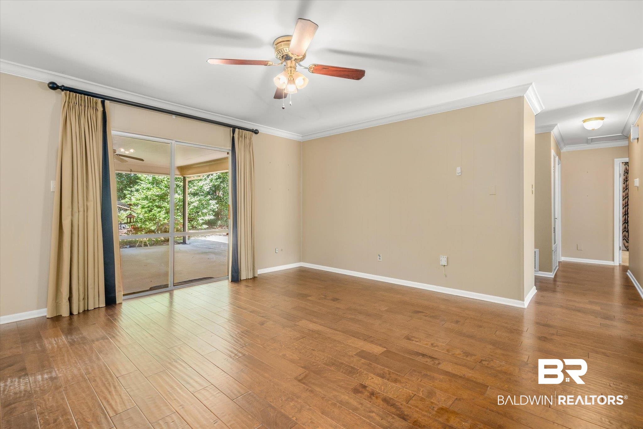 5608 Judson Circle Mobile, AL 36608 - Photo 7 of 20 Spare room featuring ceiling fan, hardwood / wood-style flooring, and crown molding