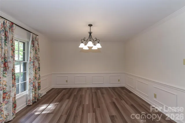 a view of room with window ceiling fan and hardwood floor
