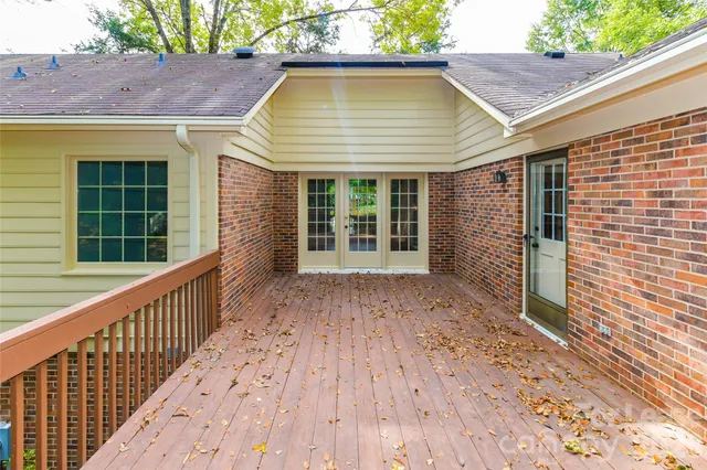 a view of balcony with wooden floor and fence