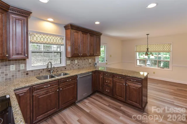 a kitchen with a sink cabinets and window