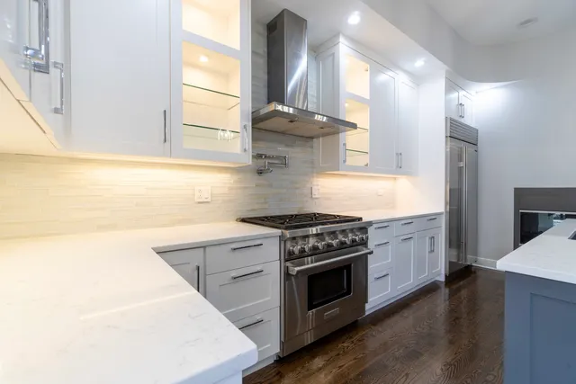 a kitchen with stainless steel appliances granite countertop a stove and a sink