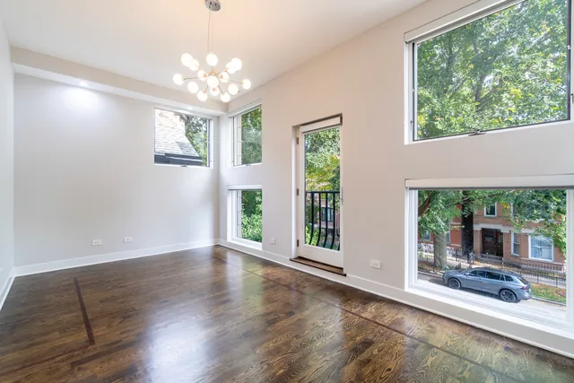 a very nice looking room with wooden floor and a large window